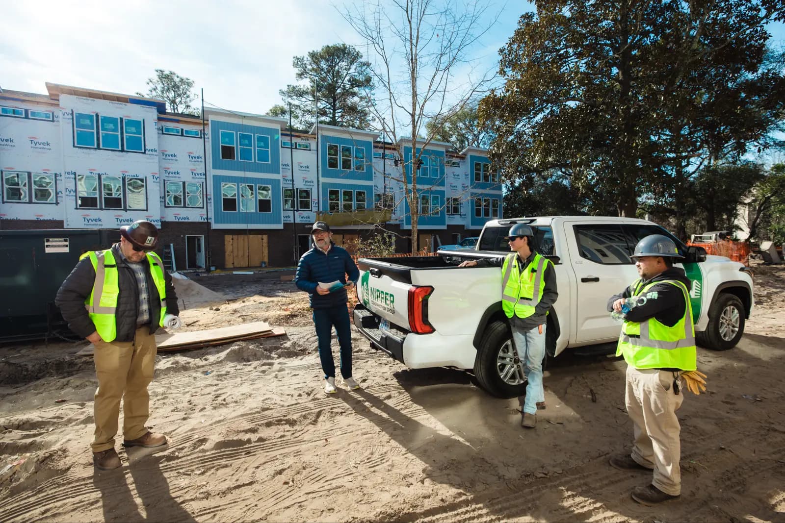 Josh Lee meeting with clients on a job site